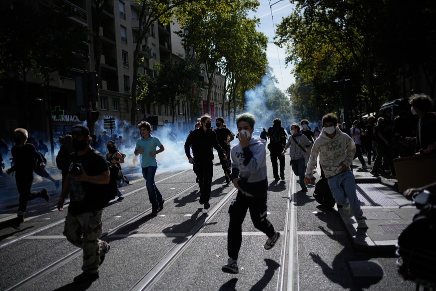 Students run out the teargas during a protest against under-resourced schools in Lyon, France, Friday, Oct. 2, 2026. (AP Photo/Laurent Cipriani)
France Protests