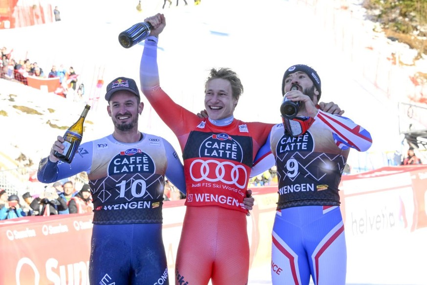 WENGEN, SWITZERLAND - JANUARY 13: Cyprien Sarrazin of Team France takes 2nd place, Marco Odermatt of Team Switzerland takes 1st place, Dominik Paris of Team Italy takes 3rd place during the Audi FIS A ...