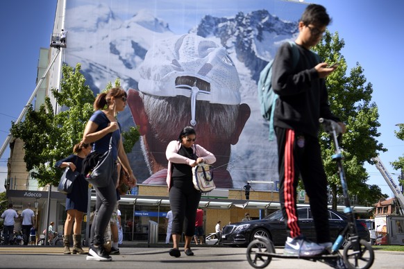 Un ouvrier fixe une image geante du photographe Martin Parr exposee sur une facade dans le cadre du festival Images ce mardi 6 septembre 2016 a Vevey. Du 10 septembre au 2 octobre, la 5e edition Festi ...