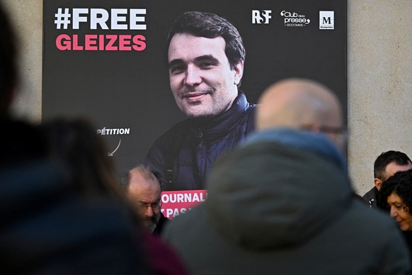 A portrait of French journalist Christophe Gleizes, who is detained in Algeria, is unveiled during a demonstration organised by the Occitanie Press Club and rights group Reporters Without Borders (RSF ...