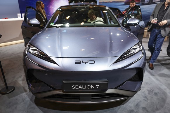 epa11760817 People visit the BYD stand at the Motor Show in Essen, Germany, 06 December 2024. The world fair for car tuning and racing takes place from 30 November to 08 December 2024. EPA/CHRISTOPHER ...