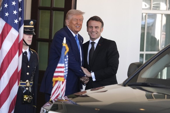 President Donald Trump, left, greets France's President Emmanuel Macron before a news conference at the White House, Monday, Feb. 24, 2025, in Washington. (AP Photo/Manuel Balce Ceneta)