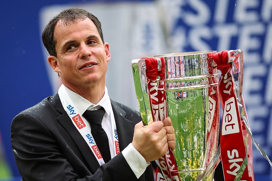 LONDON, ENGLAND - MAY 24: Regis Le Bris the head coach / manager of Sunderland poses with the trophy as he celebrates promotion to the Premier League during the Sky Bet Championship Play-Off Final mat ...