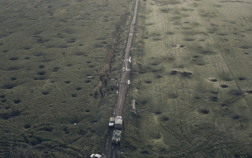 FILE - A field is covered with craters left by the shelling close to Izium, Kharkiv region, Ukraine, on Sept. 13, 2022. A series of embarrassing military losses for Moscow in recent weeks has presente ...