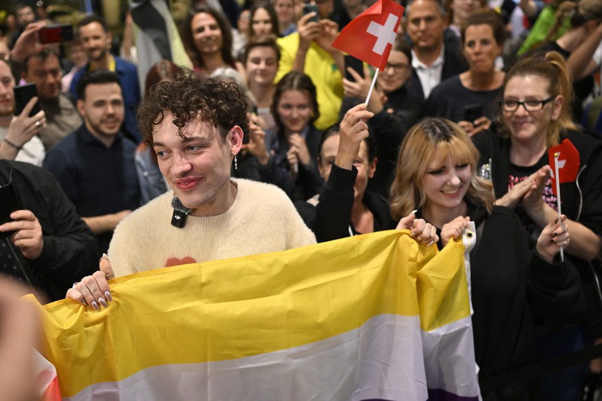 epa11336241 Swiss singer Nemo (L), the winner of the 68th edition of the Eurovision Song Contest (ESC), arrives at Zurich Airport in Kloten, Switzerland, 12 May 2024. Nemo represented Switzerland with ...