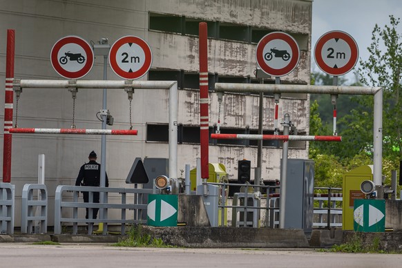 epa11339836 French policemen stand guard at the toll station of Incarville, near Rouen, in the North of France, where gunmen ambushed a prison van on 14 May 2024, killing two prison guards and helping ...