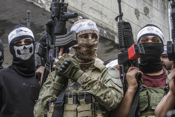 May 5, 2023, Nablus, West bank, Palestine: Masked Palestinians from the Al-Aqsa Martyrs Brigades, the Lions Den and the Balata Brigade take part during the parade, in the Balata refugee camp, east of  ...