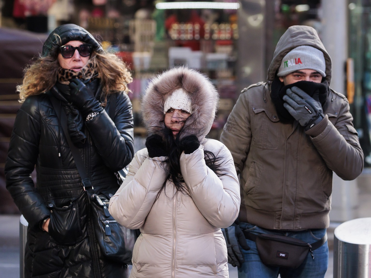epa10446086 People brace themselves against a cold wind as they walk through Times Square in New York, New York, USA, 03 February 2023. According to the National Weather Service, a cold airmass moving ...