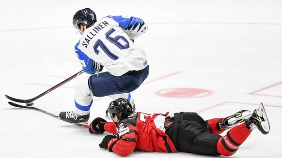 epa07603668 Jere Sallinen (L) of Finland in action against Thomas Chabot (R) of Canada during the IIHF World Championship ice hockey final between Canada and Finland at the Ondrej Nepela Arena in Brat ...