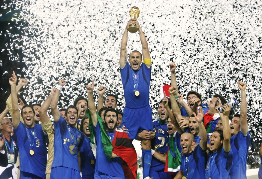 Italy's Fabio Cannavaro lifts the trophy after defeating France 5-3 in a shootout in the final of the soccer World Cup between Italy and France in the Olympic Stadium in Berlin, Sunday, July 9, 2 ...