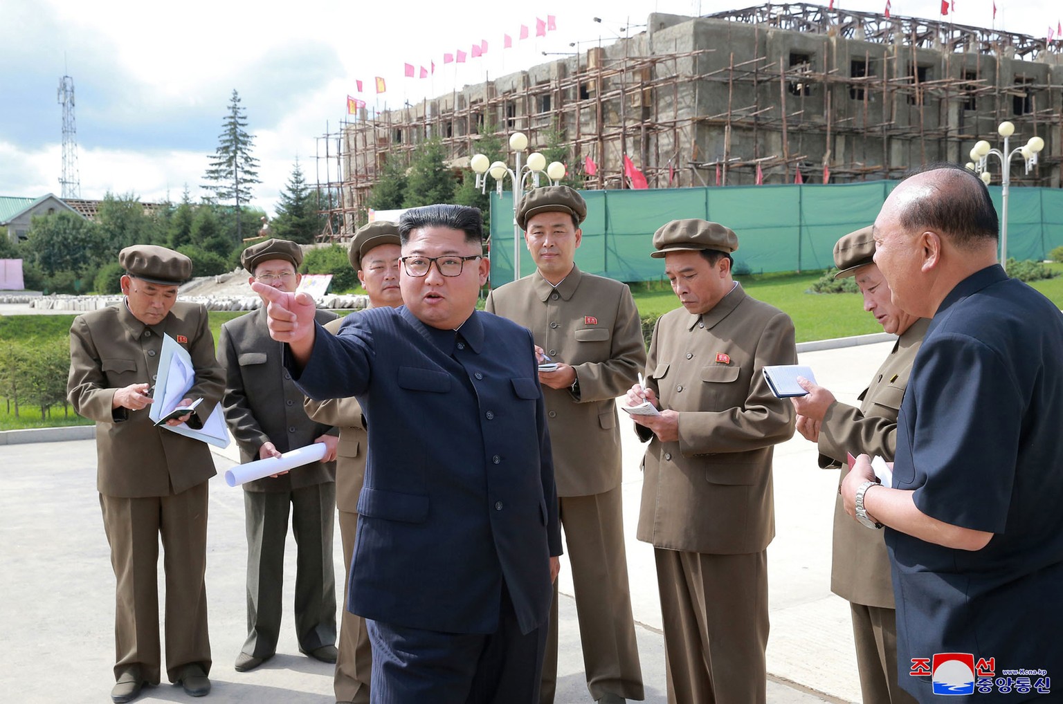 In this undated photo, provided on Aug. 19, 2018, by the North Korean government, North Korean leader Kim Jong Un, center, visits a construction site during a visit to the city of Samjiyon, a remote n ...