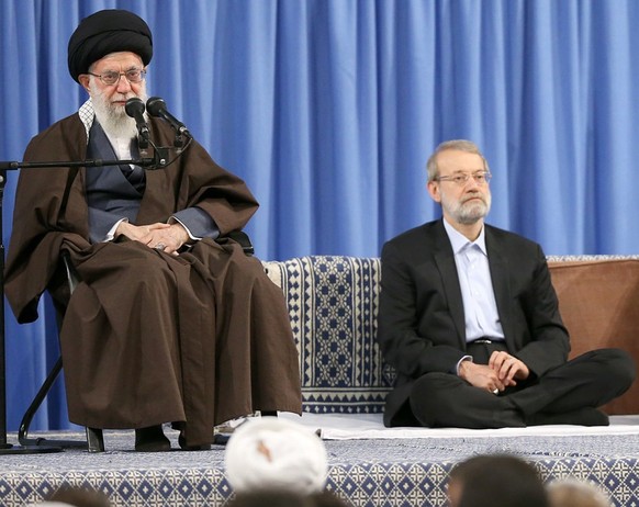 epa06668426 A handout photo made available by the supreme leader official website shows Iranian supreme leader Ayatollah Ali Khamenei (L) delivers speech to the crowds as Iranian Parliament speaker Al ...