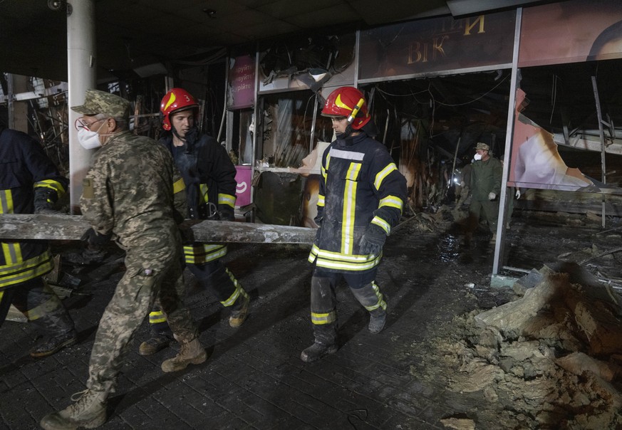 Ukrainian State Emergency Service firefighters work to extinguish a fire at a shopping center burned after a rocket attack in Kremenchuk, Ukraine, early Tuesday, June 28, 2022. (AP Photo/Efrem Lukatsk ...