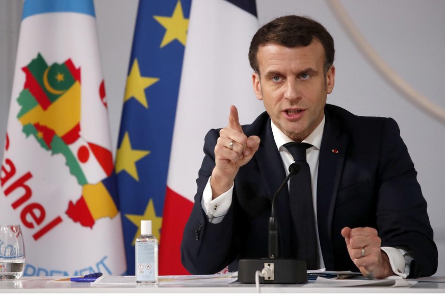 epa09016054 French President Emmanuel Macron delivers his speech after a meeting via video-conference with leaders of the G5 Sahel, in Paris, France, 16 February 2021. French President Macron urged We ...