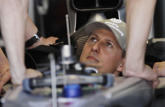 Mercedes Formula One driver Michael Schumacher of Germany sits in his car prior to the start of the first practice session at the Australian Formula One Grand Prix in Melbourne,Friday, March 26, 2010. ...