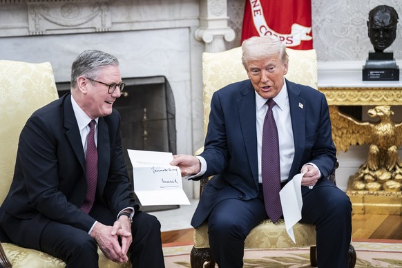 Washington, DC - February 27 : President Donald J Trump is given a letter from King Charles III, by British Prime Minister Keir Starmer in the Oval Office at the White House on Thursday, Feb 27, 2025  ...
