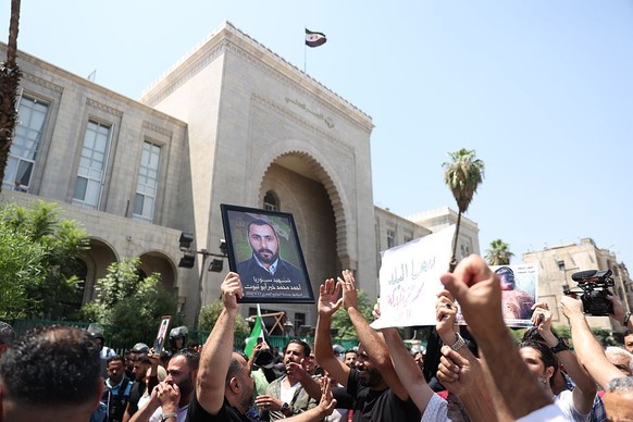 DAMASCUS, SYRIA - AUGUST 11: Syrians gather around the Palace of Justice to celebrate a court's death sentences against ousted leader Bashar al-Assad, his brother Maher al-Assad and his cousin At ...