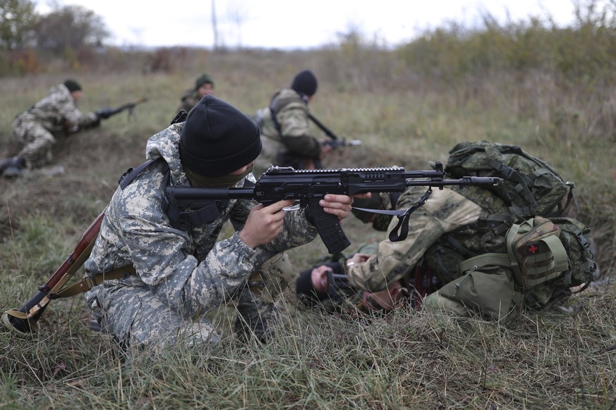 Recruits hold their weapons during military training at a firing range in the Krasnodar region in southern Russia, Oct. 21, 2022. President Vladimir Putin announced a partial mobilization in September ...