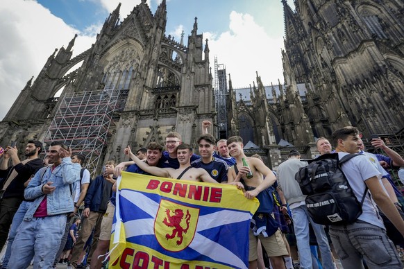 Scottish fans pose for photographs in front of the Cologne Cathedral ahead of a Group A match between Scotland and Switzerland at the Euro 2024 soccer tournament in Cologne, Germany, Wednesday, June 1 ...