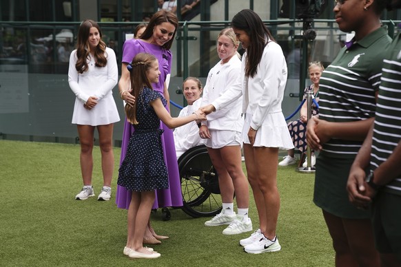Britain&#039;s Kate, the Princess of Wales and Princess Charlotte meet tennis player Emma Raducanu, at the Wimbledon tennis championships in London, Sunday, July 14, 2024. (Aaron Chown/Pool Photo via  ...