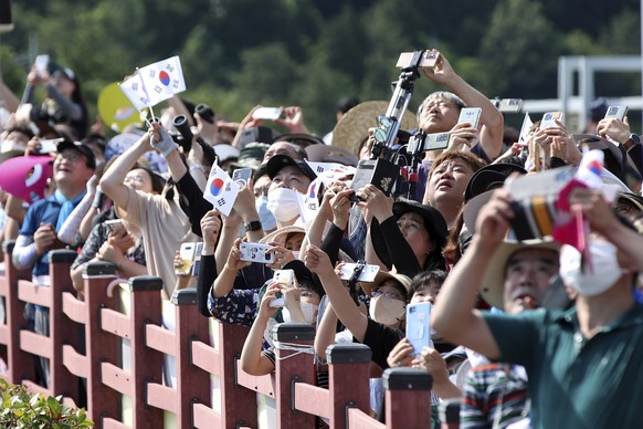 People watch the Nuri rocket, the first domestically produced space rocket, taking off from the launch pad near the Naro Space Center in Goheung, South Korea, Tuesday, June 21, 2022. South Korea launc ...