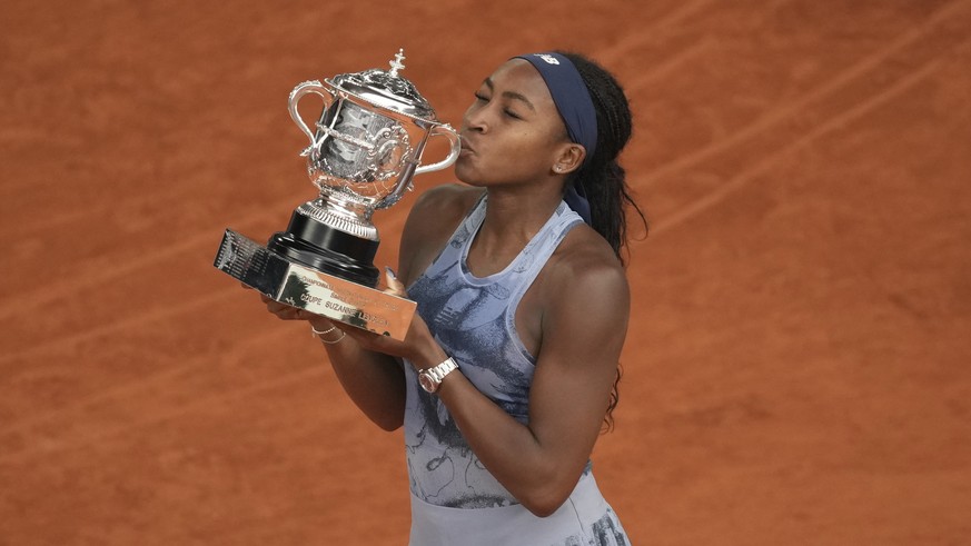 Winner Coco Gauff of the U.S. kisses the trophy after the final match of the French Tennis Open against Aryna Sabalenka of Belarus at the Roland-Garros stadium in Paris, Saturday, June 7, 2025. (AP Ph ...