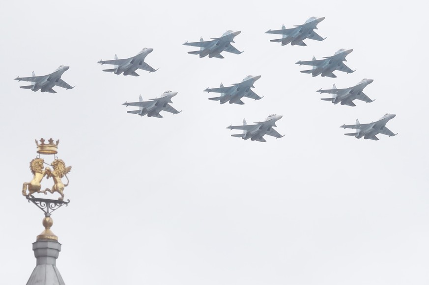 epa09186913 Russian military planes fly over the Red Square during the Victory Day military parade in Moscow, Russia, 09 May 2021. Russia holds its Victory Day parade annually on 09 May to mark the su ...