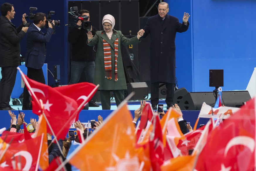 Turkish President and People&#039;s Alliance&#039;s presidential candidate Recep Tayyip Erdogan, background right, and his wife Emine Erdogan gesture to supporters during an election campaign rally in ...