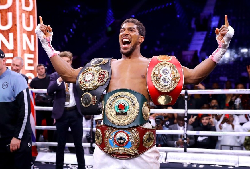DIRIYAH, SAUDI ARABIA - DECEMBER 07: Anthony Joshua poses for a photo with the IBF, WBA, WBO &amp; IBO World Heavyweight Title belts after the IBF, WBA, WBO &amp; IBO World Heavyweight Title Fight bet ...
