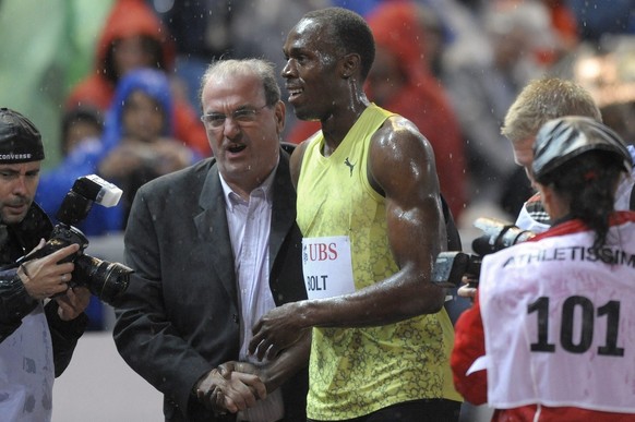 Usain Bolt of Jamaica celebrates with meeting director Jacky Delapierre after winning the men&#039;s 200 m race at the Athletissima athletics meeting in the Stade Olympique in Lausanne, Switzerland, T ...
