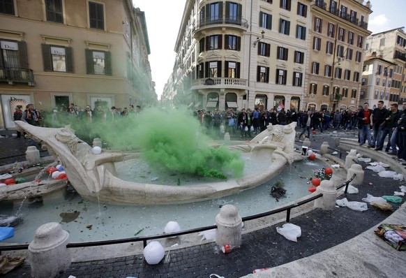 Bottles and beer cans float in the water as a flare is thrown by Feyenoord&#039;s fans in the fountain called &quot;Barcaccia&quot;, made by Pietro Bernini and his son Gian Lorenzo in 1627, at the Spa ...