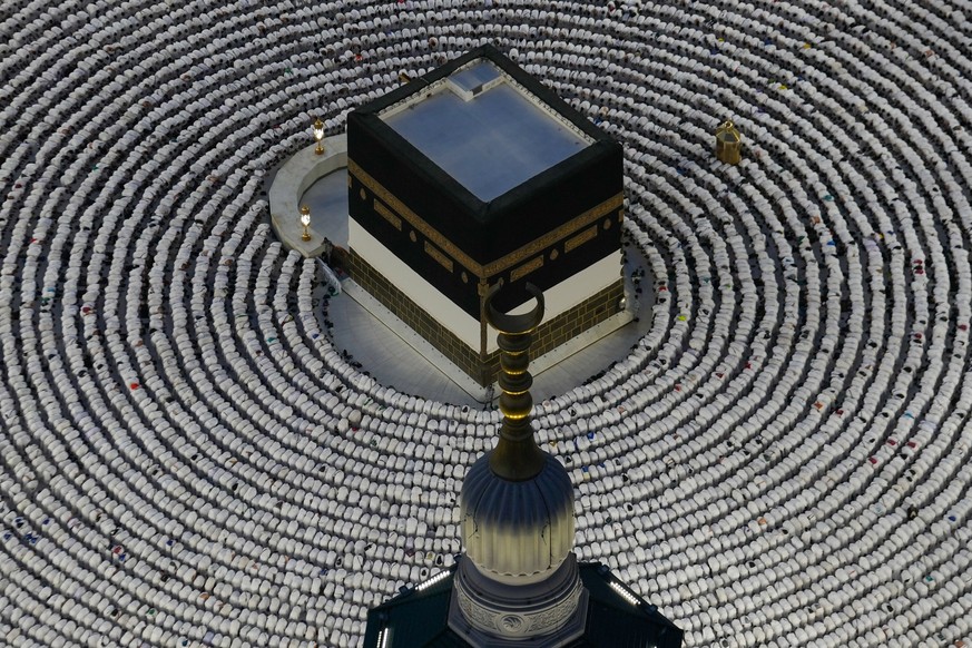Muslim pilgrims prostrate as they offer evening prayers around the Kaaba, Islam's holiest site in the holy city of Mecca during the annual hajj pilgrimage, Saudi Arabia, Sunday, May 24, 2026. (AP ...