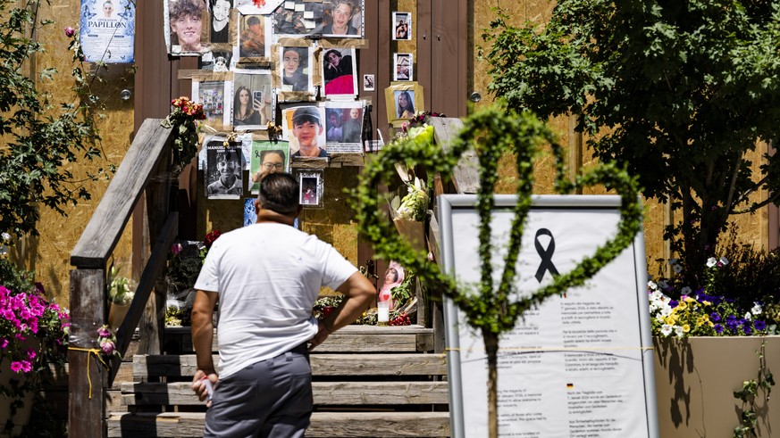 epa13100247 Portraits of the young victims are displayed at the entrance of the bar Le Constellation six months after a deadly fire, in Crans-Montana, Switzerland, 09 July 2026. Forty-one people, most ...