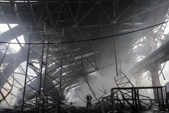 epaselect epa11047957 Ukrainian rescuers work at the site of a rocket attack on a civilian warehouse in Kyiv (Kiev), Ukraine, 29 December 2023, amid the Russian invasion. At least 16 people have died  ...