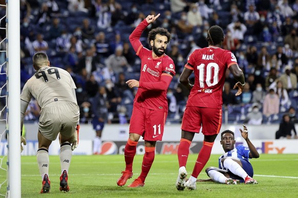 Liverpool&#039;s Mohamed Salah, center, celebrates after scoring the opening goal during the Champions League group B soccer match between FC Porto and Liverpool at the Dragao stadium in Porto, Portug ...