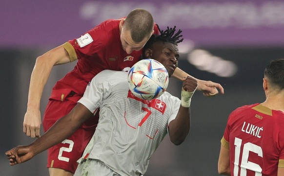 epa10345264 Strahinja Pavlovic (L) of Serbia in action against Breel Embolo of Switzerland during the FIFA World Cup 2022 group G soccer match between Serbia and Switzerland at Stadium 947 in Doha, Qa ...