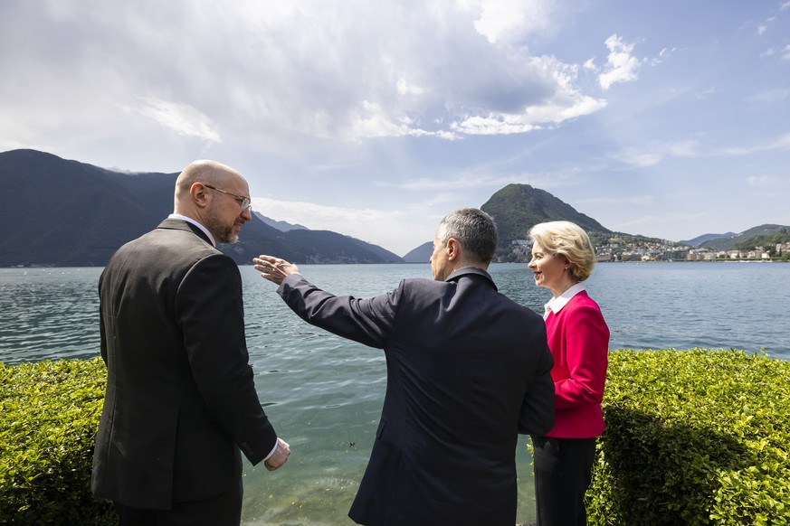 Swiss President Ignazio Cassis, center, welcomes Ursula Von der Leyen, President of the European Commission, right, and Ukrainian Prime Minister Denys Shmyhal, left, during the Ukraine Recovery Confer ...