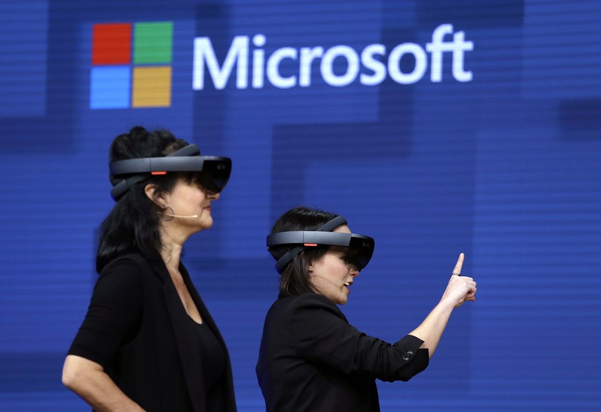 FILE- In this May 11, 2017, file photo, members of a design team at Cirque du Soleil demonstrate use of Microsoft&#039;s HoloLens device in helping to virtually design a set at the Microsoft Build 201 ...