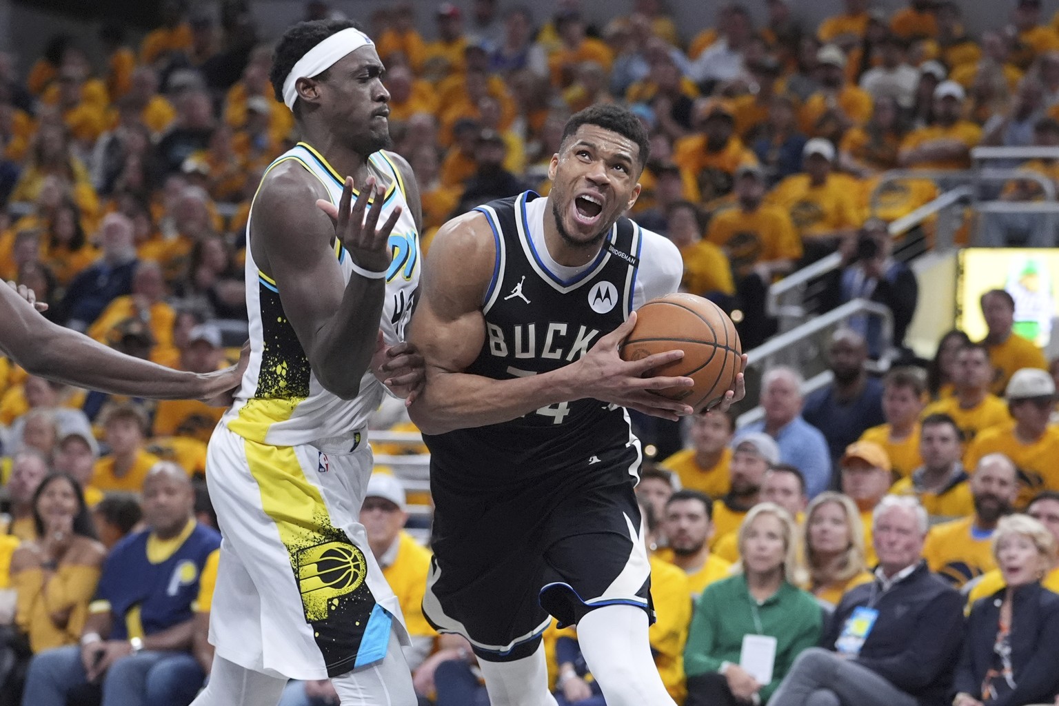 Milwaukee Bucks&#039; Giannis Antetokounmpo, right, heads to the basket as Indiana Pacers&#039; Pascal Siakam defends during the second half of a first-round NBA basketball playoff game, Saturday, Apr ...