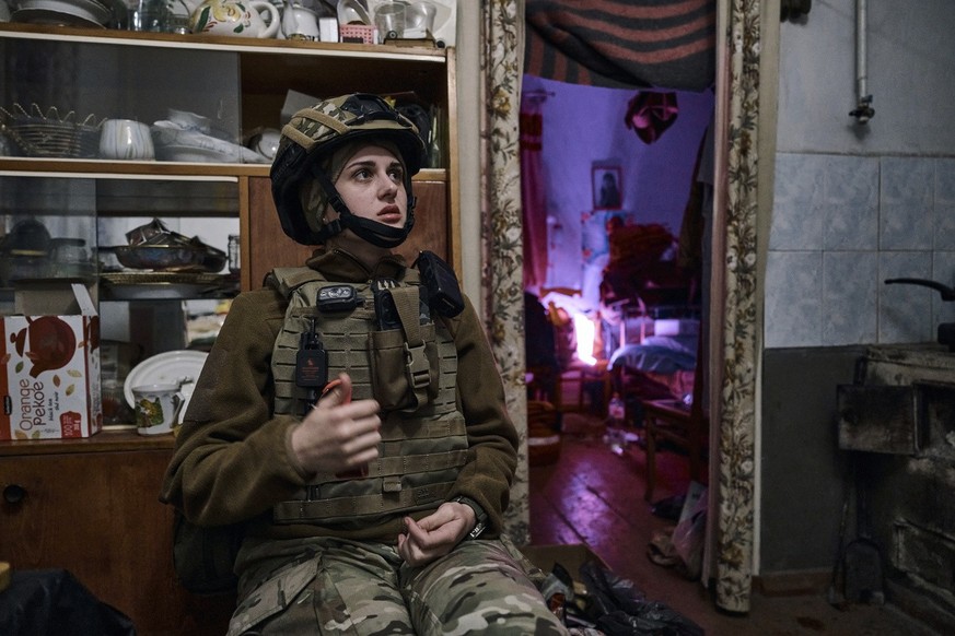 A military medic takes a short break in Bakhmut, Donetsk region, Ukraine, Sunday, April 9, 2023. (AP Photo/Libkos)