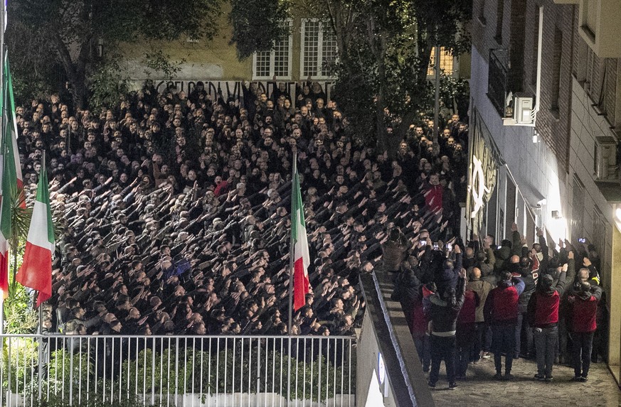 People appear to give the banned fascist salute during a rally to commemorate the slaying in 1978 of two members of a neo-fascist youth group in an attack later claimed by extreme-left militants, in R ...