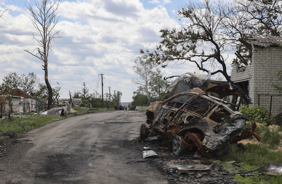 epa09980254 A destroyed car at a roadside in the village of Koropovo near Kharkiv, Ukraine, 27 May 2022. On 24 February, Russian troops invaded Ukrainian territory starting a conflict that has provoke ...