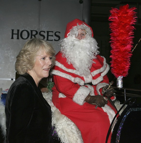 LONDON, ENGLAND - DECEMBER 19: (NO PUBLICATION IN UK MEDIA FOR 28 DAYS) HRH Camilla, Duchess of Cornwall meets Father Christmas at the London International Horse Show at Olympia on December 19, 2005 i ...