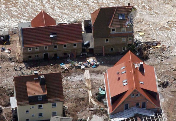 Eine Luftbildaufnahme vom Donnerstag, 15. August 2002, zeigt ein von den Wassermassen halb weggerissenes Wohnhaus im Hochwassergeschaedigten Ort Weesenstein bei Pirna nahe Dresden. (AP Photo/Stefan Th ...