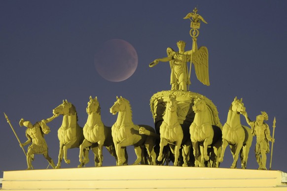 The full moon rises behind a sculpture of a chariot at the Palace Square for a total lunar eclipse in St. Petersburg, Russia, Sunday, Sept. 7, 2025. (AP Photo/Dmitri Lovetsky)
APTOPIX Russia Lunar Ecl ...