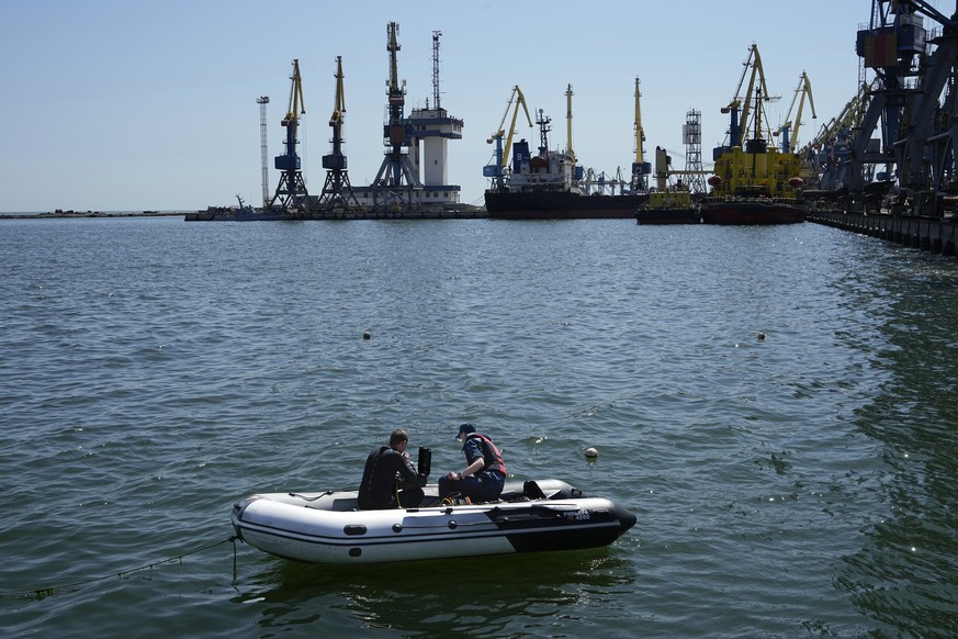 FILE - Servicemen of Donetsk People&#039;s Republic Emergency Ministry work to defuse a Ukrainian mine in an area of the Mariupol Sea Port, on April 29, 2022. Shipping companies are not rushing to exp ...