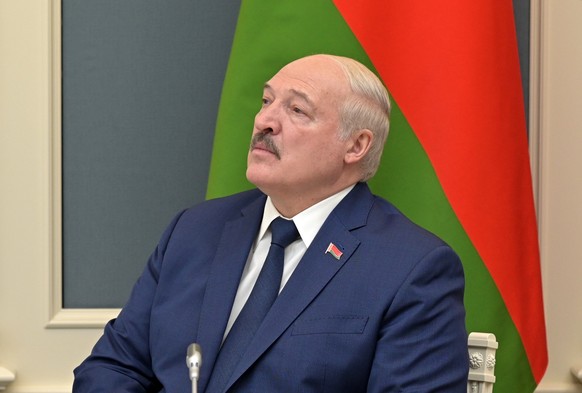 epa09771338 Belarusian President Alexander Lukashenko looks at the screen as the Russian President starts the exercises of the Russian strategic deterrence forces with launches of the ballistic missil ...