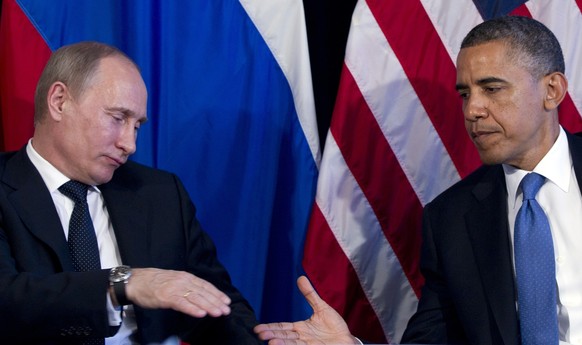 FILE - President Barack Obama and Russia&#039;s President Vladimir Putin, left, go to shake hands during their bilateral meeting at the G20 Summit in Los Cabos, Mexico, June 18, 2012. Legal and moral  ...