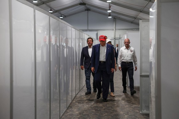 U.S. President Donald Trump, Florida Governor Ron DeSantis and U.S. Homeland Security Secretary Kristi Noem visit a temporary migrant detention center informally known as &quot;Alligator Alcatraz&quot ...