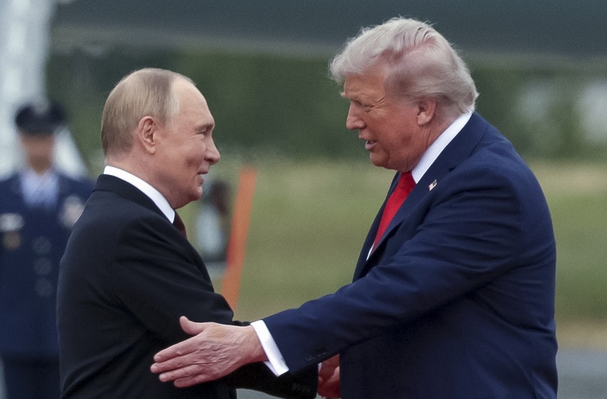 epa12303548 US President Donald Trump (R) welcomes Russian President Vladimir Putin during their meet to negotiate at Joint Base Elmendorf-Richardson in Anchorage, Alaska, USA, 15 August 2025. EPA/GAV ...